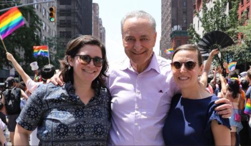NY Senator, Chuck Schumer embraces his daughter and her fiancée at the NYC Pride Parade.