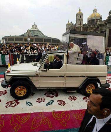 John Paul II riding in the pope mobile on the carpet of flowers in Mexico City, on July 31, 2002
