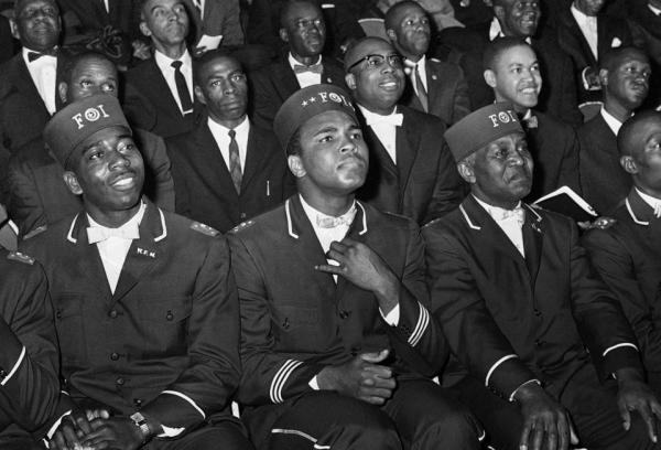 Muhammad Ali listened to Elijah Muhammad as he spoke to other black Muslims in Chicago on Feb. 28, 1966.