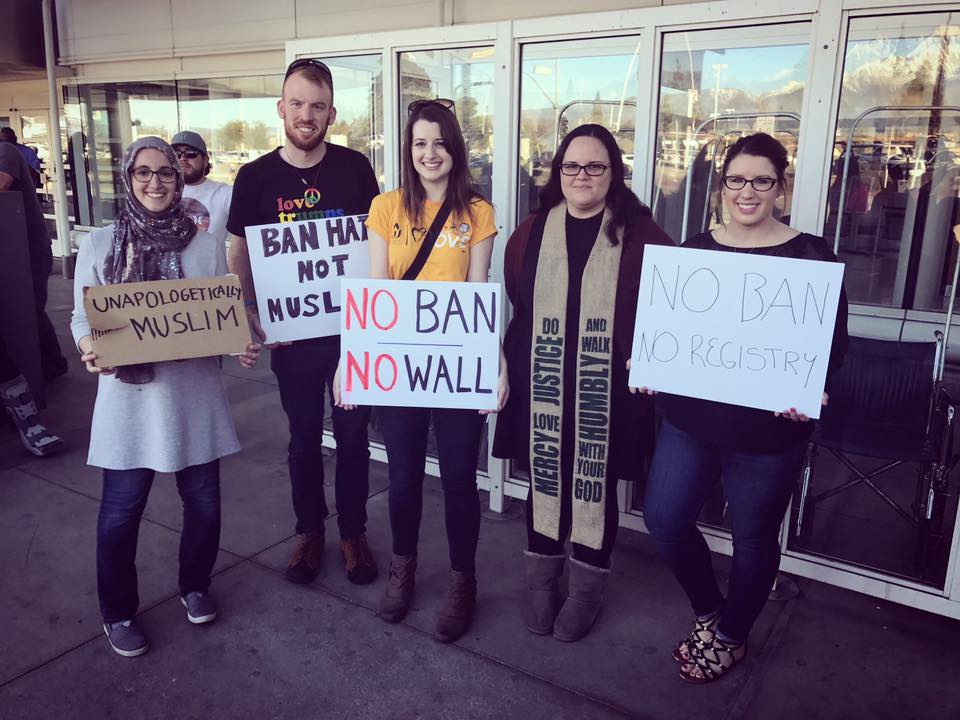 Here is Abigail Clauhs with members of her church holding up signs that say, “No Ban; No Wall””; “No Registry” and “Unapologetic Muslim.”