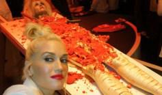 Gwen Stefani posing in front of the gory-looking red velvet dessert cake