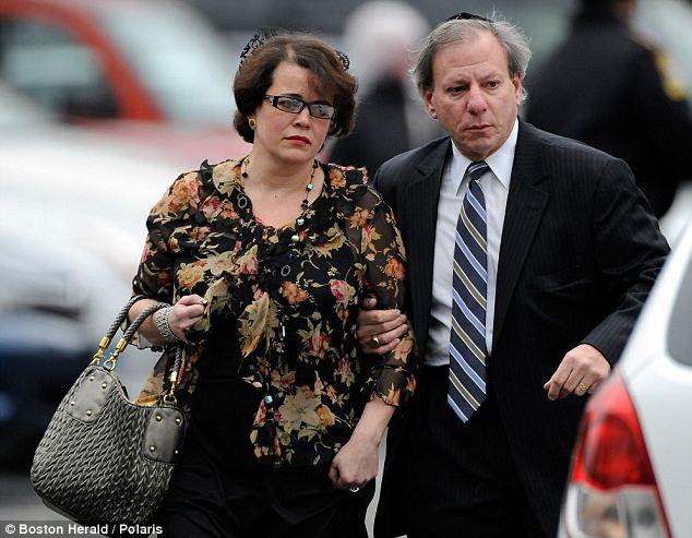 Noah Pozner’s mother, Veronique, is seen leaving her son’s funeral.