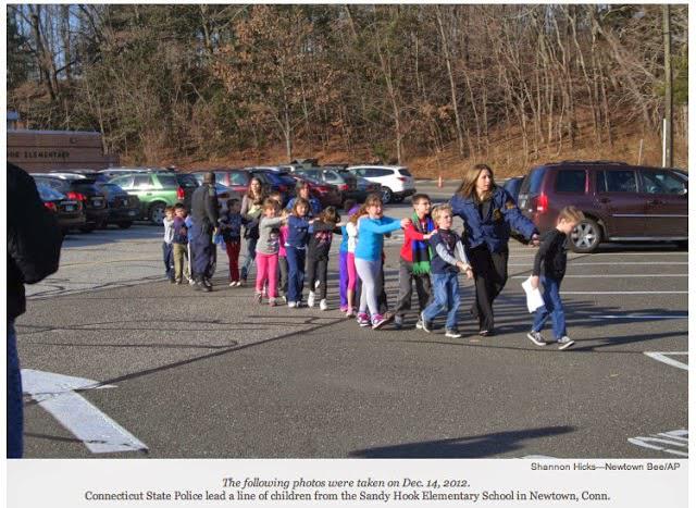 Connecticut Sate Police lead a line of children from Sandy Hook Elementary in 2012.